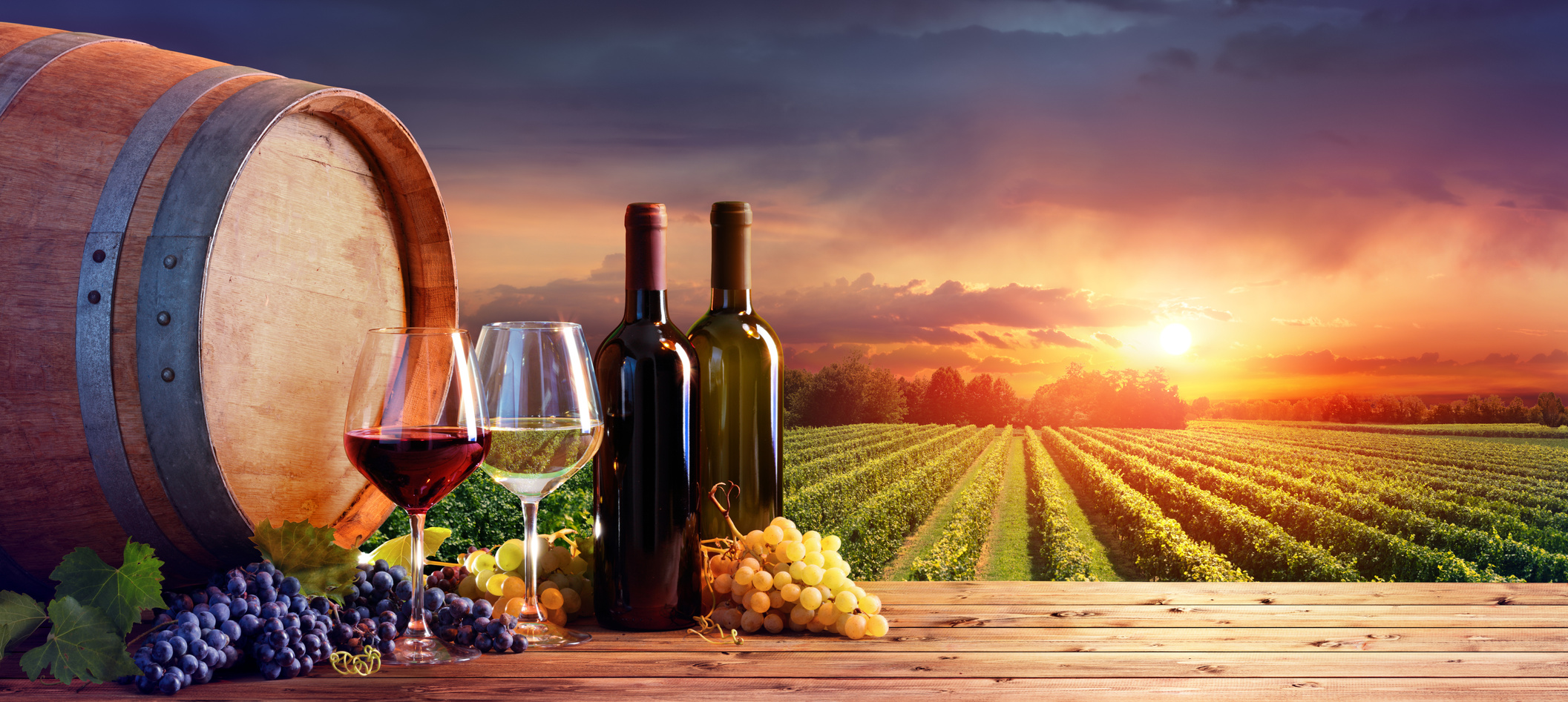 Bottles And Wineglasses With Grapes And Barrel In Rural Scene